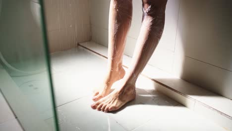 Young-woman-taking-a-shower-in-the-morning-and-shaving-her-legs-with-a-razor