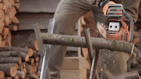 Sawyer-man-chainsawing-wood-log-with-chainsaw-in-slow-motion