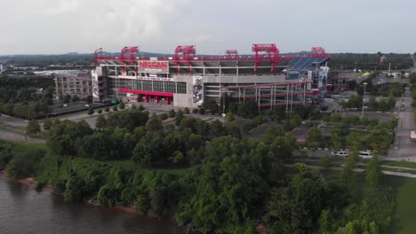 Nashville-Illinois-river-stadium-exterior-facade-and-green-landscape,-circle-aerial