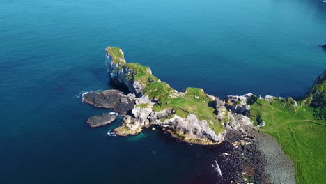 Kinbane-Castle-in-County-Antrim,-Northern-Ireland,-on-a-long,-narrow-limestone-headland-projecting-into-the-sea,-revealing-aerial-shot