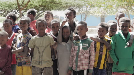 Pan-right,-slow-motion-shot-of-locals-in-Ziway,-Ethiopia-during-a-charity-event