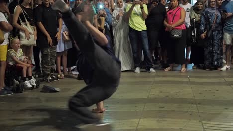 Breakdance-group-dancing-on-crowded-street-at-night