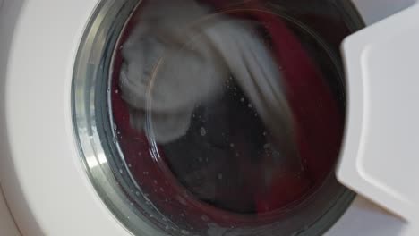 Static-shot-of-washing-machine-spinning-and-washing-clothes