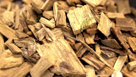 Wood-chips-being-thrown-into-a-heap-after-being-broken-down,-Close-up-rotation-shot