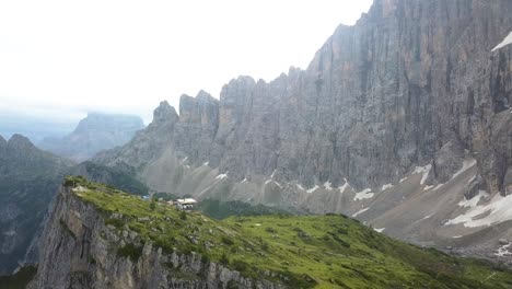 House-on-a-large-ridge-in-the-rocky-mountains-near-Alleghe-and-Refugio-Tissi-on-a-sunny-afternoon