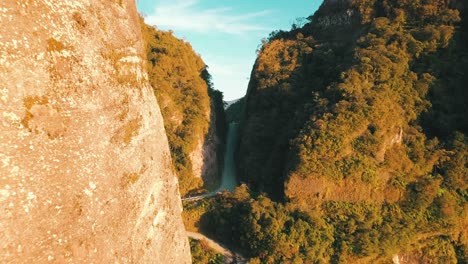 Cinematic-aerial-view-of-one-of-the-most-legendary-and-dangerous-roads-in-the-world-and-the-massive-rock-wall-on-both-sides-at-sunrise,-Serra-Do-Corvo-Branco,-Urubici,-Santa-Catarina,-Brazil