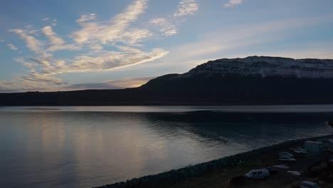 Majestic-Sunset-Over-Bay-With-Snow-Capped-Mountains-In-The-Background-In-Westfjords-Region-In-Iceland