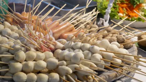 Close-up-Footage-of-Many-Kinds-of-Steamed-Skewers-Displaying-At-Street-Food-Market