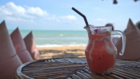 mango,-pineapple,-watermelon-and-yoghurt-or-yogurt-smoothies-jar-with-sea-beach-background