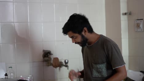 Beard-man-drinking-water-in-the-kitchen