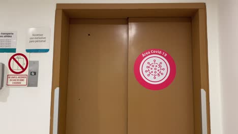 COVID-Area-red-warning-sticker-in-Elevator-front-door-in-Clinic---Hospital---Latin-America