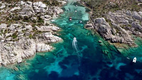 Boat-Entering-Small-Private-Cala-at-Caprera-Island,-Sardinia,-Italy
