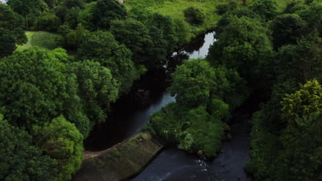 Birdseye-shot-of-a-river-and-rural-neighborhood-located-in-Bushmills