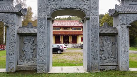 Passing-through-stone-portal-with-arches-outside-traditional-Buddhist-temple