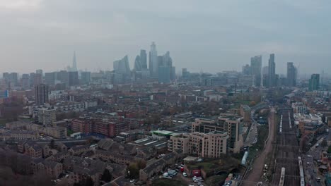 dolly-back-drone-shot-of-Central-London-Skyline-over-overground-railway-lines
