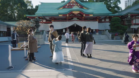 Family-Wearing-Masks-While-Visiting-Hie-Shrine-During-The-Pandemic---Tokyo,-Japan---Medium-Shot,-Slow-Motion