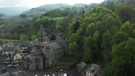 Beautiful-misty-hills-surrounding-a-Romanesque-style-French-church