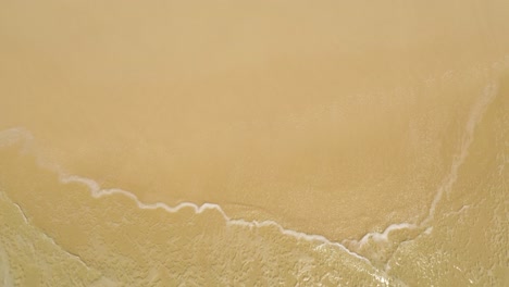 Aerial-view-of-sea-waves-on-sandy-beach