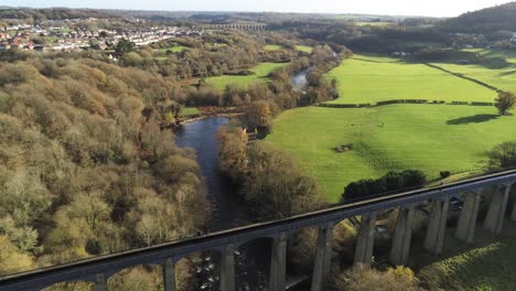 Old-Welsh-Pontcysyllte-Aqueduct-waterway-aerial-view-rural-Autumn-woodlands-valley-rising-dolly-left