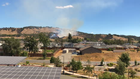 Air-tanker-drops-fire-retardant-on-grass-and-wildfire-approaching-residential-homes