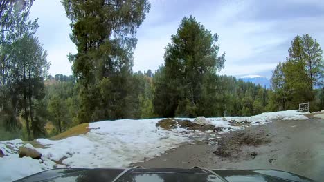 4x4-vehicle-driving-through-narrow-mountainous-roads-covered-with-snow-during-winters