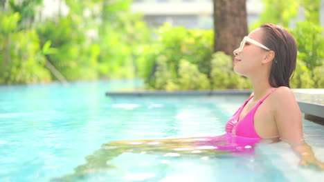 Pretty-Asian-Female-Enjoying-in-Pool-on-Bright-Summer-Day