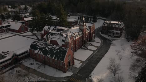 Aerial-View-Of-Bishop's-University-With-Snow-In-Sherbrooke,-Quebec-During-Winter---orbiting-drone-shot