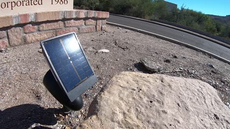 The-sun-reflects-off-a-small-solar-panel-used-to-power-the-light-positioned-below-it