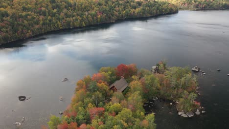 Aerial-View,-Lakefront-House-and-Colorful-Flashy-Forest-in-American-Countryside