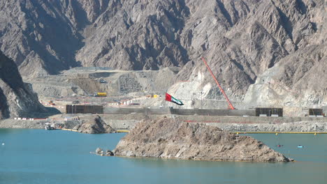 UAE-Flag-waving-by-construction-site-and-kayaks-in-the-Hatta-Dam-Lake