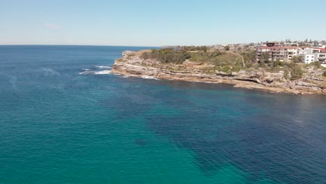 Aerial-view-of-coastline-by-Bondi-Beach-on-sunny-summer-day,-Sydney-Australia