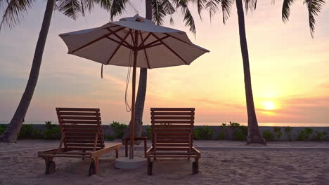 Empty-Beach-Beds-and-Parasol-For-Two-on-Sunset-Sunlight-at-Tropical-Destination