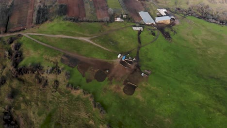 Sheepfold-On-Lush-Green-Hill-In-Romania---Aerial-Shot