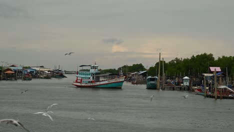 Wooden-Big-Boat-crossing-an-estuarine-channel-in-Samut-Sakhon,-Thailand