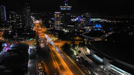 4K-UHD-Time-lapse-of-car-traffic-on-road-and-people-crossing-street-at-night-in-downtown-Broadbeach-district,-Gold-Coast-Australia,-aerial-view