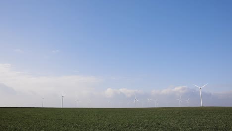 Wind-Farm---Wind-Turbines-On-A-Green-Field-On-A-Sunny-Day