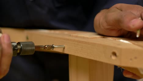 Closeup-Shot-Of-Workers-Assembling-Wood-Furniture-With-Screws,-Woodworking-Manufacturing-Industry