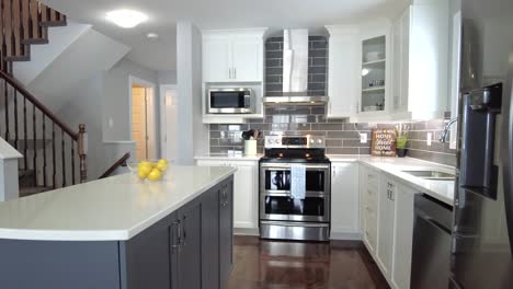 real-estate-high-end-kitchen-reveal-from-behind-stainless-fridge-smooth-gimbal
