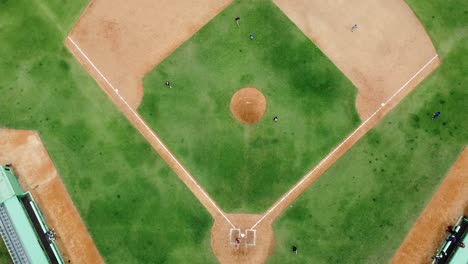 San-pedro-de-macoris,-DR---March-12,-2021---top-view-of-young-people-practicing-baseball-at-stadium-in-san-pedro,-training-session