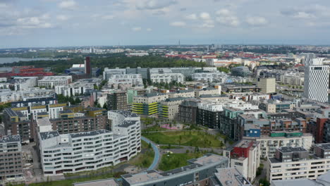 Park-with-paths-in-Helsinki-city-centre-among-buildings,-drone-shot
