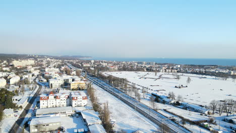 Aerial-view-of-Gdansk-city-urban-winter-landscape-from-high-point-on-a-sunny-day,-slow-forward-motion