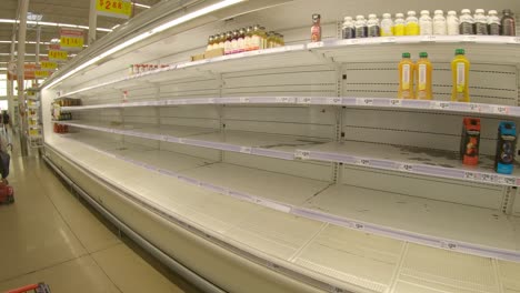 Almost-empty-refrigerated-shelves-for-juice-at-HEB-grocery-store