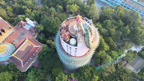 4k-Top-down-Aerial-panning-around-The-Wat-Samphran-Temple-with-huge-dragon-coiled-around-in-Amphoe-Sam-Phran-province-in-Bangkok,-Thailand
