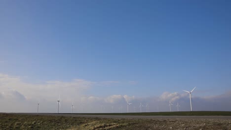 Onshore-Horizontal-Axis-Wind-Farm-Turbine-In-Green-Field-At-Clear-Blue-Sky---wide-angle-shot