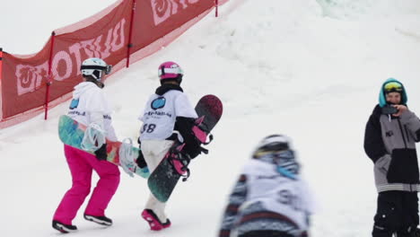 Two-Snowboard-Girls-High-Five-on-a-Snowboard-Competition-in-Sweden