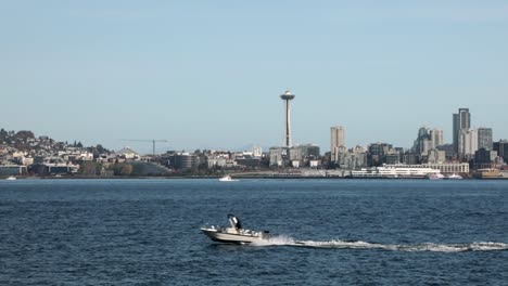 Speedboat-Passing-At-Elliot-Bay-With-Space-Needle-And-Seattle-Center-In-Background-In-Seattle,-Washington,-United-States