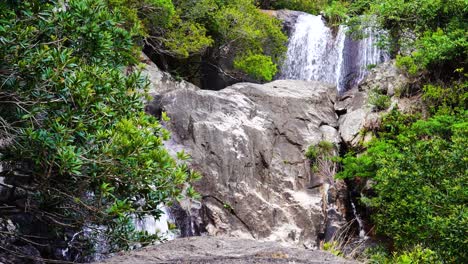 Waterfall-cascades-on-rock-in-virgin-emerald-green-rainforest,-Vietnam