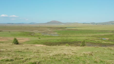 Mountain-valley-wetland-marsh-bog,-countryside-wildlife-habitat,-aerial-view