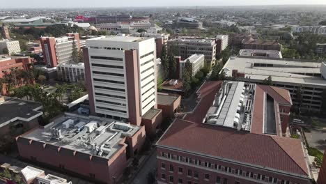 University-of-Southern-California-campus,-rising-aerial-over-building