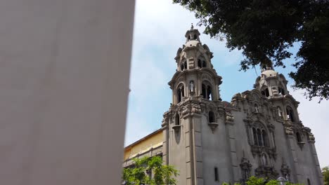 4k-daytime-revealing-video-of-the-facade-of-the-Catholic-Church-"Parroquia-la-Virgen-Milagrosa"-in-front-of-Kennedy-Park,-Lima,-Peru